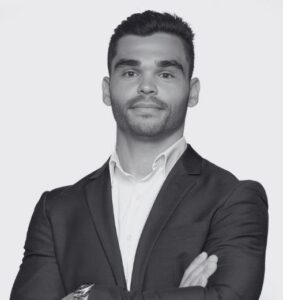 Black and White Headshot of Alex Economo. Arms crossed