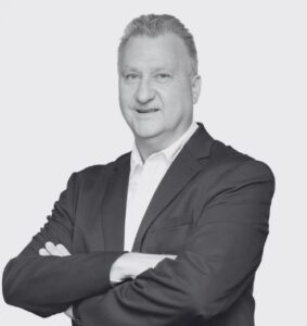 Black and White Headshot of Cary Paddick. Arms crossed