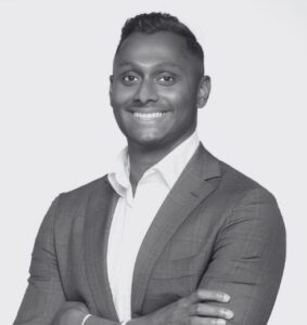 Black and White Headshot of Rohan Kandiah. Arms crossed